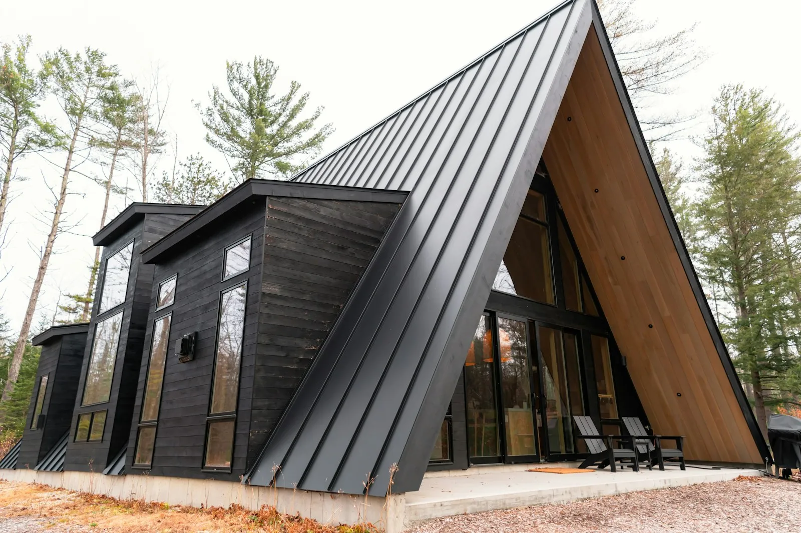 A modern home with a durable standing seam metal roof against a clear sky